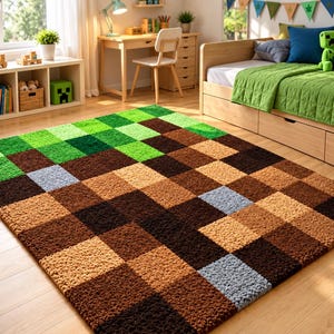 May include: A rectangular area rug featuring a pixelated block pattern in shades of green, brown, and light grey. The rug has a textured, tufted surface composed of small square sections that mimic a digital landscape design on a floor.