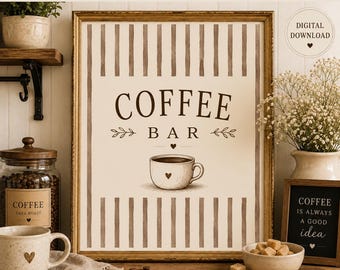 May include: A framed wall art print featuring the text COFFEE BAR in dark brown letters above a drawing of a coffee cup with a small heart. The background has vertical brown stripes on a cream surface. The print is displayed in a gold frame.