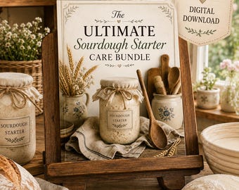May include: A 20-page digital download guide titled The Ultimate Sourdough Starter Care Bundle, displayed on a wooden easel. The image features a glass jar of sourdough starter, a wooden spoon, and rustic kitchen decor on a wooden surface.