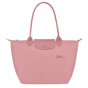 May include: A dusty rose tote bag featuring a textured leather flap with a silver-toned snap button closure, two matching shoulder straps, and a small embroidered horse and rider logo on the front. The bag has a zipper closure at the top.