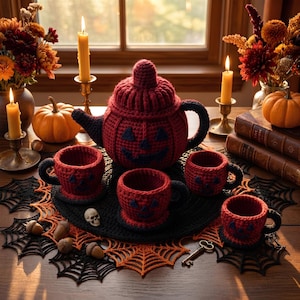 May include: A crochet tea set featuring a dark red teapot and four matching cups, each decorated with dark blue jack-o'-lantern faces. The set sits on a black and orange spiderweb-patterned crochet mat, surrounded by candles and autumn decor.