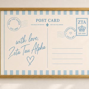 May include: A framed print designed as a vintage postcard with light blue and cream stripes. The text reads POST CARD, with love, Zeta Tau Alpha, and includes a stamp graphic with a crown, a postmark, and lines for an address in blue ink.
