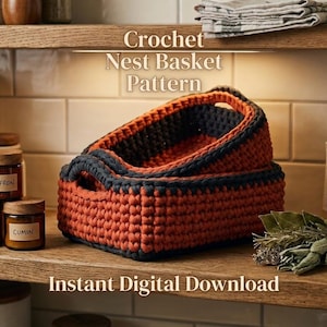 May include: Two nested rectangular crochet baskets featuring a textured stitch pattern in burnt orange with dark charcoal gray rims and integrated handles. The text Crochet Nest Basket Pattern and Instant Digital Download is visible.
