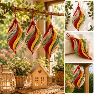 May include: Three teardrop-shaped crochet ornaments featuring spiraling panels in red, yellow, sage green, and cream. Each ornament is topped with a red crocheted cap, a wooden bead, and a hanging loop, with a small red bead at the pointed base.