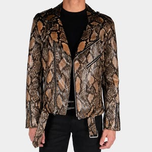May include: A motorcycle jacket featuring a brown and black snakeskin pattern. The jacket includes a notched lapel, an asymmetrical front zip closure, silver-toned metal hardware, zipped cuffs, and an adjustable belt at the waist.