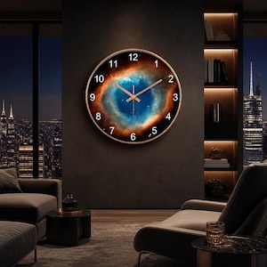 May include: A round wall clock featuring a vibrant nebula print on its face, displaying a deep blue centre surrounded by glowing orange and black cosmic clouds. The clock has a thin metallic frame, white Arabic numerals, and slender hands.