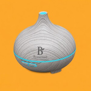 May include: A light gray wood grain aromatherapy diffuser with a rounded shape. The device features a blue LED light ring, two control buttons labeled 1H, 3H, 6H, ON, and the logo Beauritual with the text Your Calming Aromatherapy Experience.