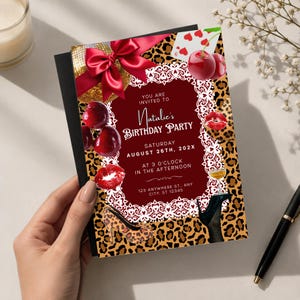 May include: A rectangular birthday party invitation card featuring a leopard print background, a central dark red panel with white lace trim, and text reading You Are Invited To Natalie's Birthday Party Saturday August 26th, 202X.