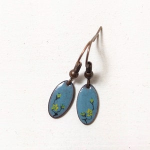 black, oval enamel earrings painted with dots