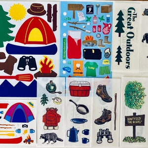 May include: A set of colorful camping themed stickers featuring a variety of images including a tent, a campfire, a canoe, binoculars, a bear, a tree, and a sign that says "The Great Outdoors".
