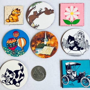 May include: Nine round, colorful, paper coasters with various designs.  One coaster features a cartoon cat, another has a cartoon bear, another has a cartoon car, another has a cartoon hot air balloon, another has a cartoon church, another has a cartoon flower, another has a cartoon cat, another has a cartoon cat, and another has a cartoon cat.