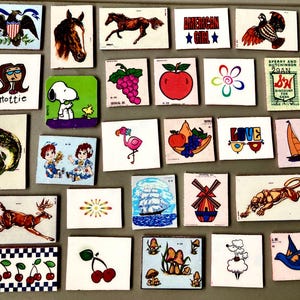 May include: A collection of vintage, small square images with various illustrations. The images include a horse, an eagle, Snoopy, a flamingo, an apple, cherries, and the text "AMERICAN GIRL". The images are in various colors and styles.
