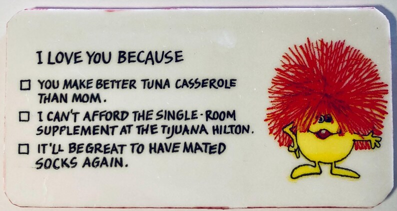 May include: A rectangular white plaque with the text "I LOVE YOU BECAUSE" and three humorous reasons. A cartoon character with red hair and a yellow body is on the right side.