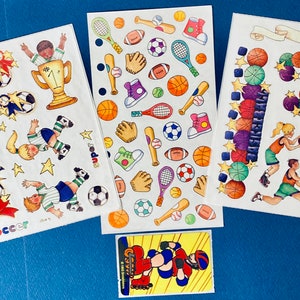May include: Three sheets of colorful stickers featuring sports-themed illustrations. The stickers include images of children playing soccer, basketball, and baseball. The stickers also feature sports equipment, such as soccer balls, basketballs, baseball bats, and tennis rackets.