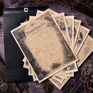 May include: A stack of beige paper sheets titled Divination Session Folio Tarot Oracle with dark botanical illustrations and a grid for card readings. The sheets feature printed sections for date, time, question, and notes, layered over a black envelope.