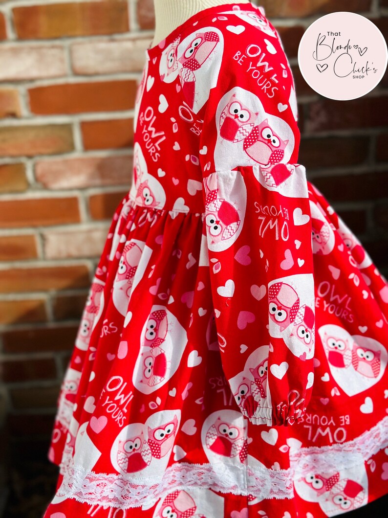 May include: Red dress with white owls and hearts. The dress has a white lace trim and the text "Owl Be Yours" is repeated throughout the design.