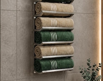May include: A wall-mounted metal towel rack featuring six angled shelves, each holding a rolled towel. The towels alternate between dark green and beige colors, and each towel features three thin white stripes near the rolled edge.