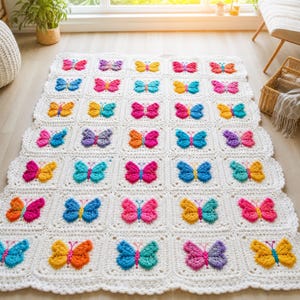 May include: A rectangular crochet blanket featuring a repeating grid of white square motifs, each containing a three-dimensional butterfly in various colors including pink, blue, yellow, orange, and purple, with a scalloped white border edge.