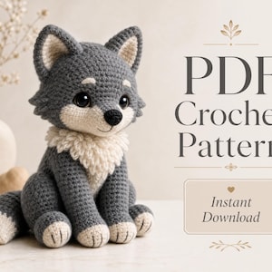 May include: A gray and cream crocheted wolf plush toy with large black eyes and a fluffy chest. The text reads PDF Crochet Pattern and Instant Download. The design features pointed ears, a dark nose, and a long tail with a cream-colored tip.