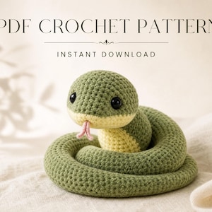 May include: A PDF crochet pattern for a coiled snake toy. The snake is made of olive green yarn with a pale yellow underside, black plastic eyes, and a small pink forked tongue. The text PDF CROCHET PATTERN and INSTANT DOWNLOAD are visible.
