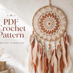 May include: A circular dream catcher featuring a cream and terracotta crochet mandala inside a wooden hoop. Hanging from the hoop are several crocheted leaf-shaped ornaments and long fringe tassels in cream and terracotta. Text reads PDF Crochet Pattern.