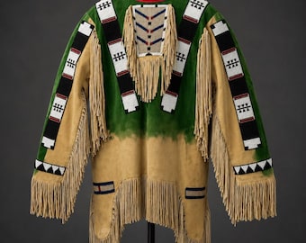 May include: A tan and green suede pullover shirt featuring long fringe trim, a red collar, and intricate geometric beadwork patterns in white, black, and red. The garment includes a central beaded chest panel and beaded bands along the sleeves.