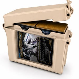 May include: A beige plastic storage case with a hinged lid, designed to hold trading cards. The front features a clear display window showing a card titled Goniti, Noble Architect, while the interior compartment holds additional card decks.