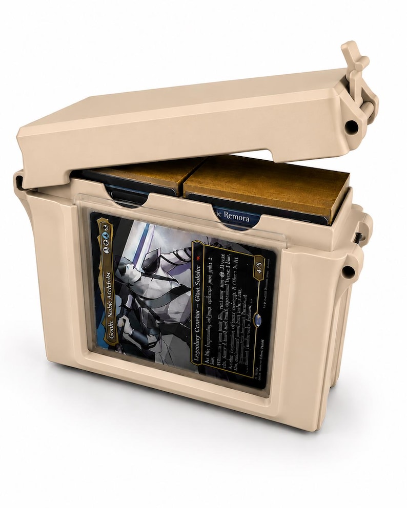 May include: A beige plastic storage case with a hinged lid, designed to hold trading cards. The front features a clear display window showing a card titled Goniti, Noble Architect, while the interior compartment holds additional card decks.