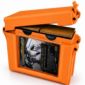 May include: A bright orange, rectangular hard-shell storage case with a hinged lid. The front features a clear window displaying a trading card titled Gorlin, Nokie Aetereist. Inside, two dark brown card decks are visible through the open top.