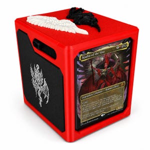 May include: A bright red cubic card storage box featuring a display slot on the front holding a Kaalia of the Vast trading card. The top surface is adorned with a white wing and a black wing emblem, while the side panel displays a white dragon icon.