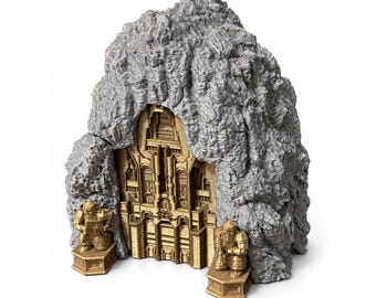May include: A gray 3D printed mountain structure featuring a central gold-colored ornate gate with intricate architectural details. Two gold-colored figures stand on hexagonal pedestals at the base of the mountain entrance.