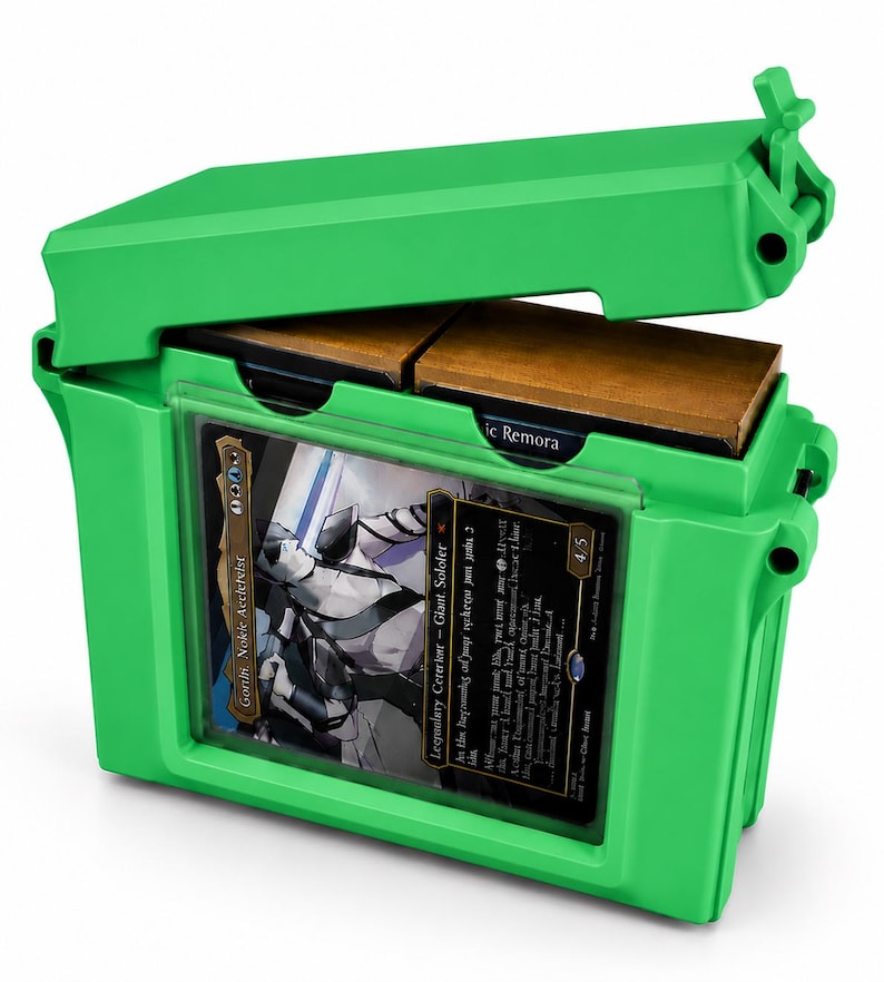 May include: A bright green plastic deck box with a hinged lid, featuring a clear front window displaying a Magic: The Gathering card titled Goro-Goro, Disciple of Ryusei. The box contains two internal compartments holding stacks of trading cards.