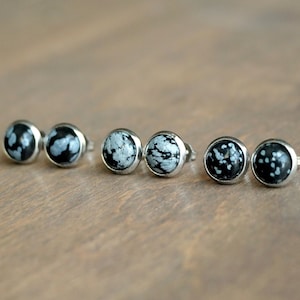 May include: Six silver stud earrings with black and white snowflake obsidian stones.