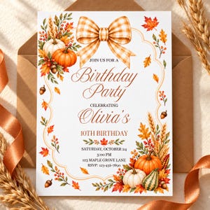 May include: A white rectangular birthday party invitation card featuring a large orange and white gingham bow at the top. The border is decorated with watercolor illustrations of pumpkins, acorns, wheat, and autumn leaves. Text reads: JOIN US FOR A Birthday Party CELEBRATING Olivia's 10TH BIRTHDAY SATURDAY, OCTOBER 24 3:00 PM 123 MAPLE GROVE LANE RSVP: 123-456-7890.
