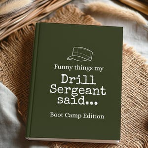 May include: A dark olive green hardcover journal featuring a white line drawing of a military cap at the top. The text reads: Funny things my Drill Sergeant said... Boot Camp Edition, printed in a mix of white serif and typewriter-style fonts.