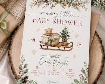 May include: A rectangular baby shower invitation card featuring a watercolour illustration of a teddy bear in a basket on a wooden sled, surrounded by pine branches, berries, and snowflakes. The text reads A merry little BABY SHOWER, Honoring Cindy Wright, and includes event details for Saturday December 15th at 3pm, 123 Merry Lane, and RSVP to Ann.