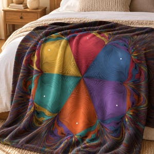 May include: A soft throw blanket featuring a vibrant, kaleidoscopic fractal pattern. The design displays a central star-like arrangement with distinct segments in yellow, red, blue, teal, orange, and purple, surrounded by swirling, marbled edges.
