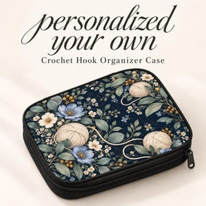 May include: A rectangular crochet hook organizer case with a black zipper and a dark blue floral pattern featuring white and blue flowers, green leaves, and beige yarn balls. The text reads personalized your own Crochet Hook Organizer Case.