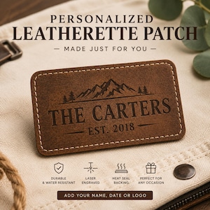 May include: A rectangular brown leatherette patch with rounded corners and white perimeter stitching. The patch features a laser-engraved mountain range graphic, the text THE CARTERS, and EST. 2018. Text above reads PERSONALIZED LEATHERETTE PATCH.