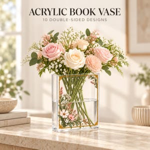 May include: A clear rectangular acrylic book vase featuring a gold-toned frame graphic and floral illustrations. The text ACRYLIC BOOK VASE 10 DOUBLE-SIDED DESIGNS is printed above. The vase is filled with a bouquet of pink and white roses and greenery.