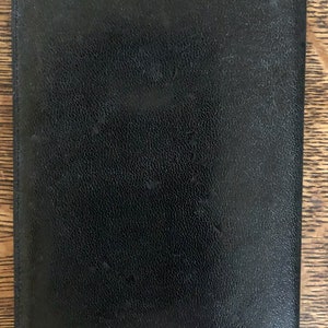 May include: A black leather wallet with a textured surface.