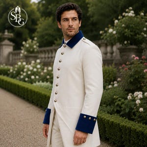 May include: A long-sleeved, off-white military-style coat featuring a high collar, deep blue cuffs, and a vertical row of metallic buttons down the front. The garment includes shoulder epaulets and a structured, tailored fit with a clean design.
