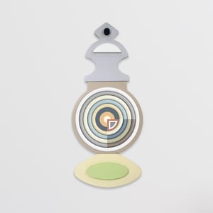 May include: Abstract wall art with a layered design. The artwork features concentric circles in pastel shades, a light grey top, and a green oval base. A small black dot is at the top. The piece is likely made of wood or similar material.