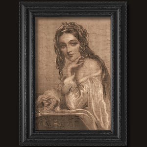 May include: A framed sepia-toned print featuring a portrait of a person with long wavy hair, wearing a textured garment and holding a string of beads. The background consists of faint musical notation, all enclosed in a black ornate frame.