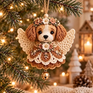 May include: A crocheted dog ornament featuring brown and white yarn, wearing a floral crown and angel wings. The figure is adorned with small fabric flowers at the neck and hangs from a jute string with a small gold-toned metal bell at the base.