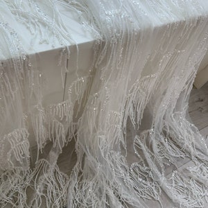 Off white bead lace fabric with fringes for dress