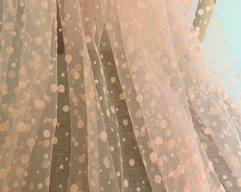 Peach pink polka dotted tulle fabric