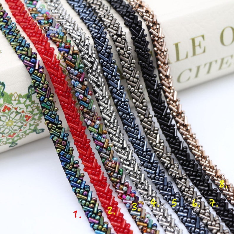 May include: Eight different beaded trims with a chevron pattern. The trims are in various colors, including black, silver, red, and multi-colored.