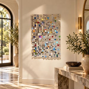 May include: A rectangular wall art piece composed of a grid of small, reflective metallic squares. The surface features a mix of silver-toned tiles interspersed with individual squares in vibrant shades of blue, red, green, and orange.