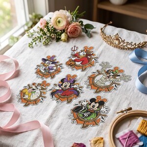 May include: A collection of six die-cut stickers featuring Disney characters in Halloween costumes, including Mickey Mouse, Minnie Mouse, Donald Duck, Daisy Duck, Goofy, and Pluto, each framed by a ship's wheel and small bats.